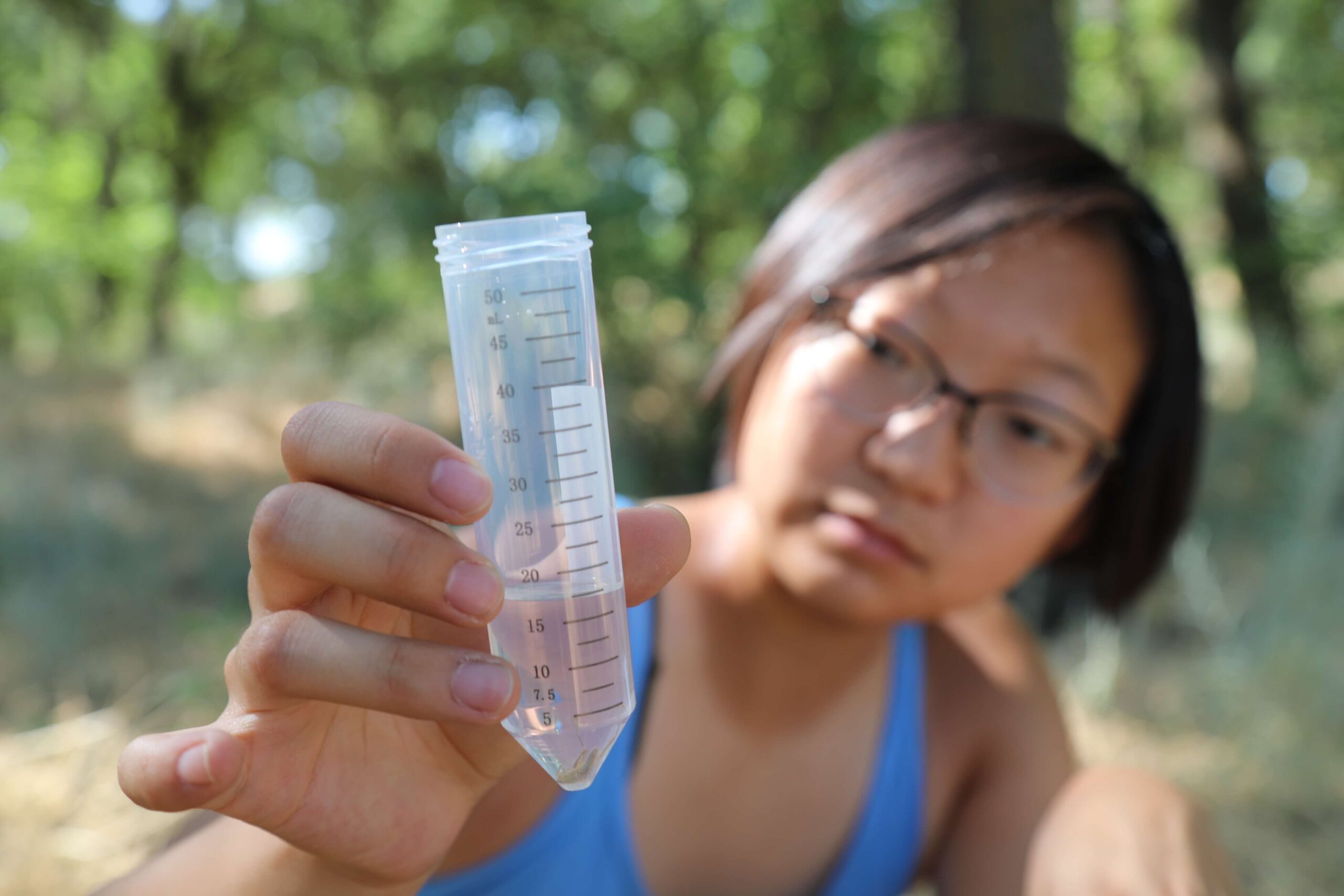 woman holding a vial of insects
