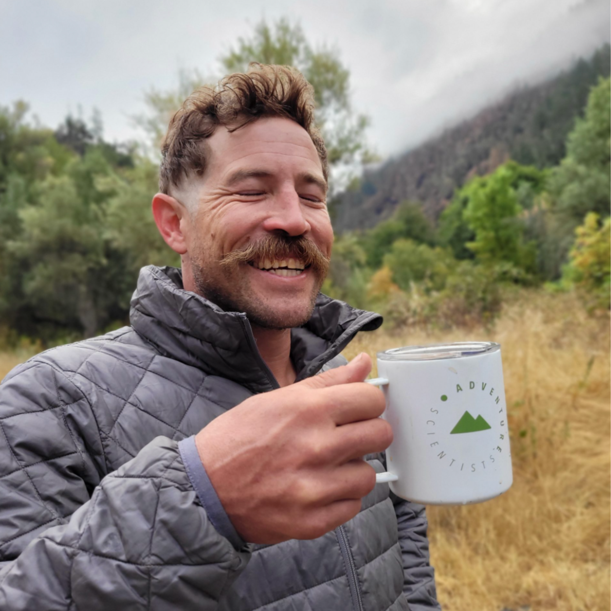Image of volunteer holding a cup donated by Miir