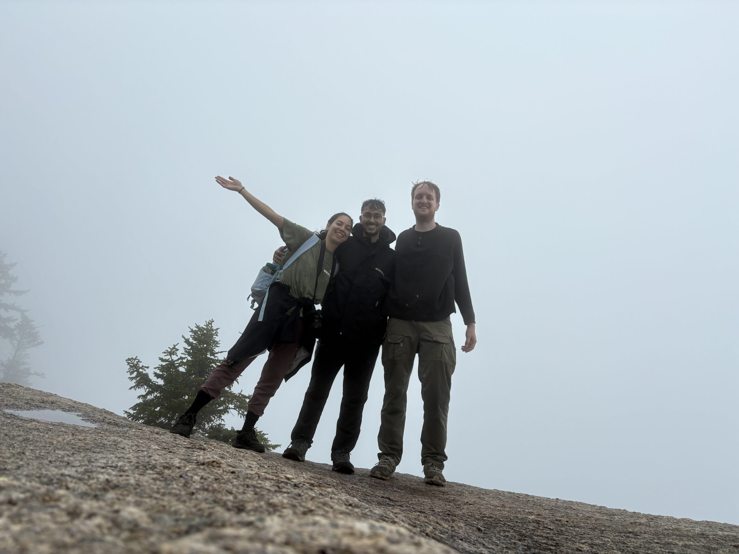 volunteers snap a quick photo in the white mountains of new hampshire - a far drive from their home in New York City