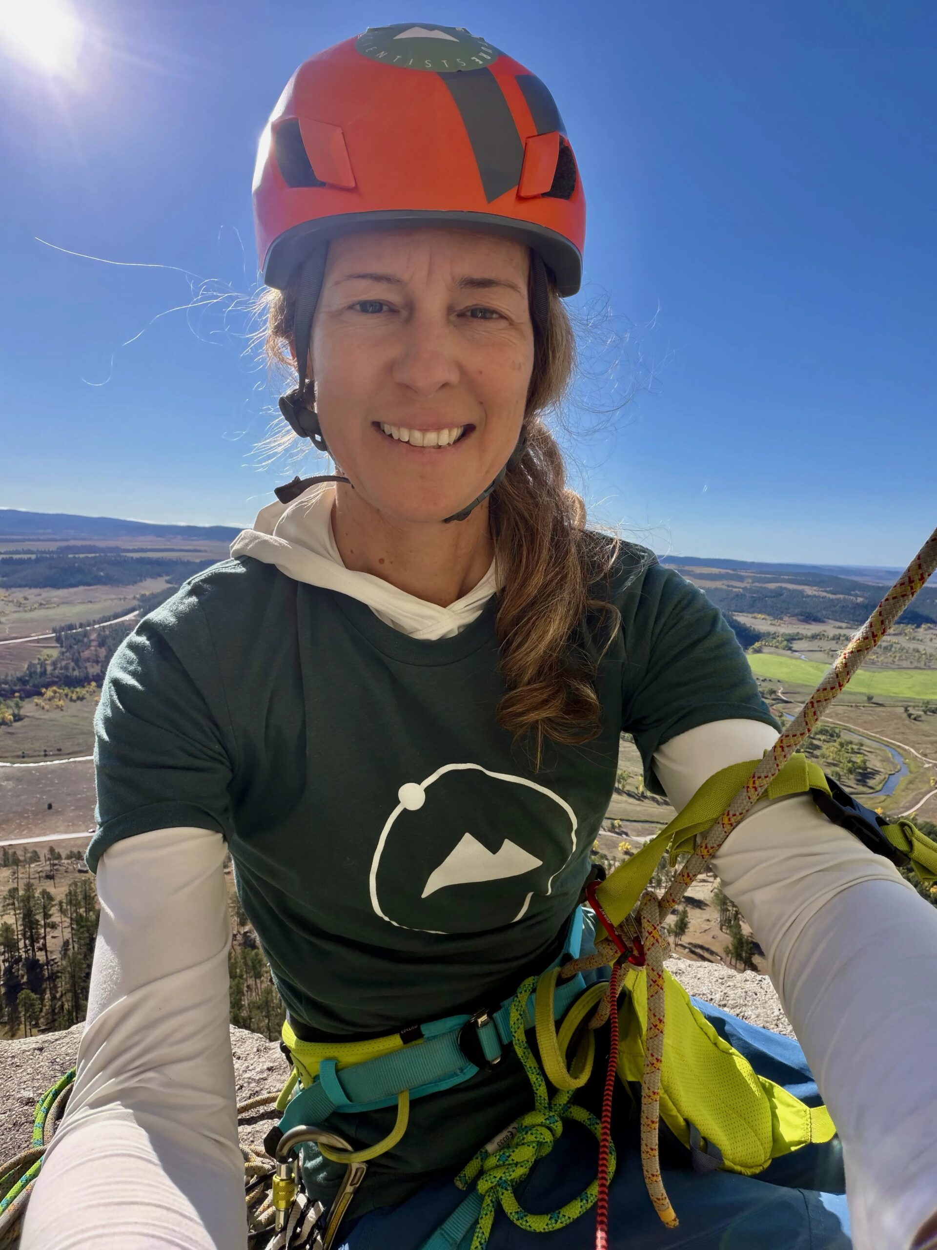 Executive Director, Lara Birkes, climbing Devil's Tower in Wyoming