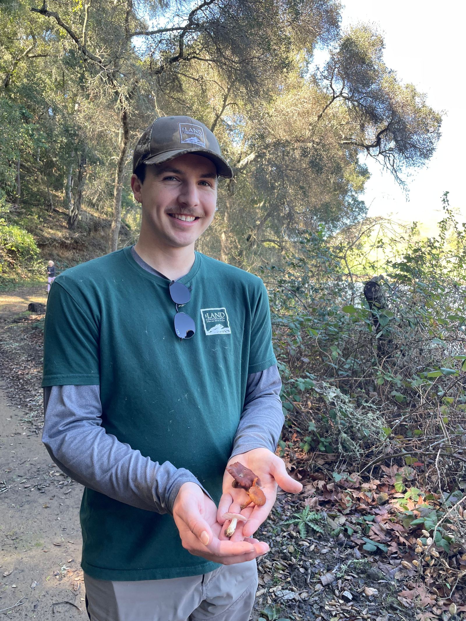 A volunteer holds out a collected sample in cupped hands.